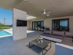 a living room with a couch and a tv at Apartment in Croatia near the Coast in Brtonigla