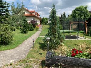 einen Garten mit einer Bank und einem Picknicktisch in der Unterkunft Villa Lypche in Bešeňová