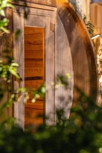 una puerta de madera con un espejo en una habitación en Escale Rochelaise, gîte urbain avec SPA bain nordique et sauna tonneau, en La Rochelle