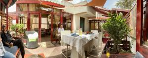 a group of people sitting around a table on a patio at Kefetew Guest House in Addis Ababa