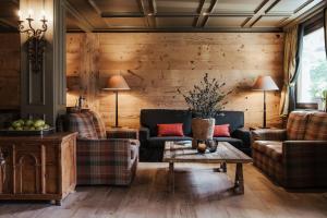 a living room with two couches and a table at Hotel Alù Mountain Design in Bormio