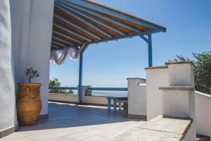 a patio with a table and a view of the ocean at DP Homes Paros in Angairiá