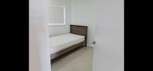 a small bed in a room with a window at 2 Bedroom Modern Home at 61A Glenn St Dean Park NSW in Schofields