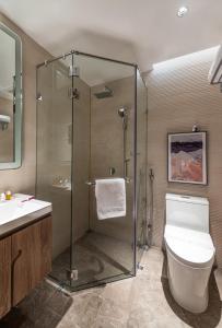 a bathroom with a shower and a toilet and a sink at Boudl Khamis Mushait in Khamis Mushayt