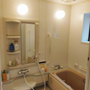 a bathroom with a tub and a large mirror at STAYAI in Ibaraki
