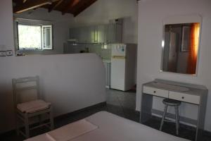 a kitchen with a white refrigerator and a counter top at Anastasia Apartments in Kámpos