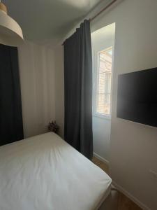 a bedroom with a white bed and a window at Zadar Enjoy Apartment in Zadar