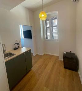 a kitchen with a sink and a counter top at Zadar Enjoy Apartment in Zadar
