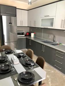 a kitchen with a table with chairs and a sink at SYRIOS House & Apartments in Nafplio