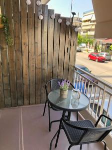 a table and chairs on a balcony with a fence at SYRIOS House & Apartments in Nafplio +20 photos