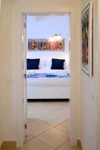 a bedroom with a bed through a doorway at Branco Suites - Rooms & Holiday Apartments in Santa Maria
