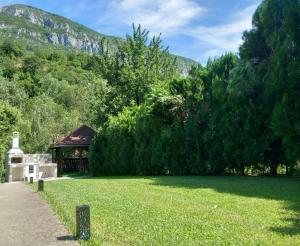 a garden with a gazebo in the middle of a field at Casa Peneșel in Băile Herculane
