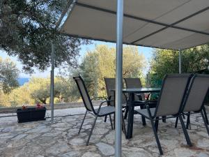 a table and chairs under an umbrella on a patio at Mikes View in Astros