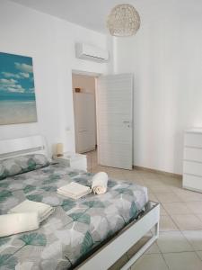 - une chambre blanche avec un lit dans l'établissement Casa Kalé, à Aci Castello