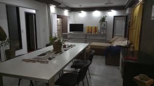 a kitchen and living room with a white table and chairs at Don Pedro in San Carlos