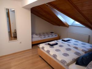 a bedroom with two beds and a large window at Studio apartman Ivana in Jajce