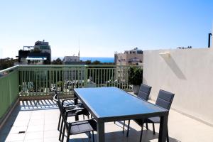 a blue table and chairs on a balcony at A wonderful sea view duplex in Tel Aviv