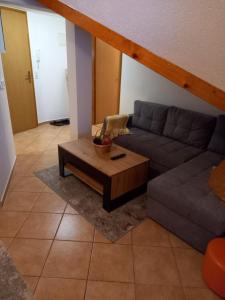 a living room with a couch and a coffee table at Studio apartman Ivana in Jajce