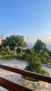 a stone walkway with a railing and a view of the ocean at Anemos Pelion Seaview in Kala Nera