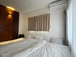 En eller flere senge i et værelse på 青梅森の宿