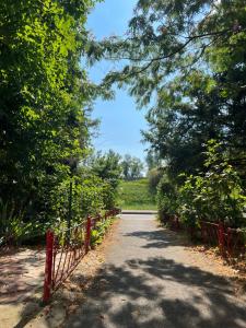 a path with a red fence and trees at Kalim’s apartment in Arad