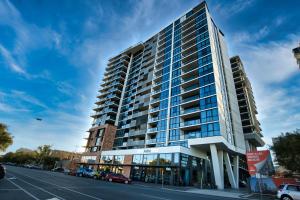 a tall building on the side of a street at Modern 2BR Apt in Adelaide CBD with Pool-Gym-BBQ in Adelaide