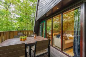 a patio with a table and chairs on a deck at Maison Juliette Durbuy in Durbuy
