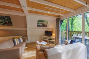 a living room with a couch and a table at Maison Juliette Durbuy in Durbuy