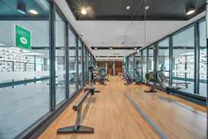 a gym with treadmills and ellipticals in a building at Luxury Disney 3 BR Apt- Pool-Gym-Sauna-Steam Room in Adelaide