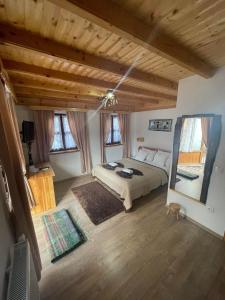 a bedroom with a bed in a room with wooden ceilings at Rustic Lodge Plitvice in Jezerce