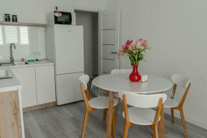 a kitchen with a table with a vase of flowers on it at Apartment 5 star Werewolf in Strizhavka