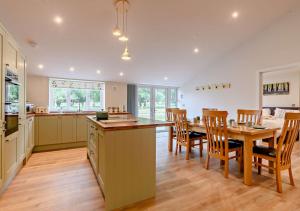 a kitchen and dining room with a table and chairs at Roosters Rest in Beccles