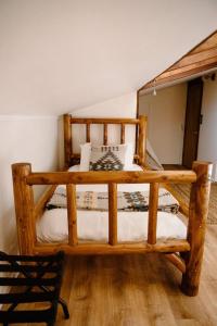 a wooden bunk bed in the corner of a room at The Lodge at Silver Ridge Ranch in Cabin Creek