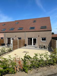 a house with a patio in front of it at THE 77 work or holiday new home in Houthem