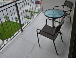 a balcony with a table and a table and a chair at Best Apartments-Aqua-Belgrade Waterfront in Belgrade