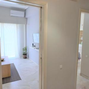 an open door to a room with a living room at Central, Bright and Comfortable Apartment with balcony in Athens