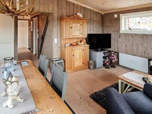 a living room with a couch and a tv at Holiday home Engerdal 