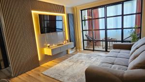 a living room with a couch and a mirror at Cosy 2 rooms apartment in the center of the city in Bucharest