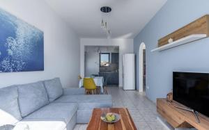 a living room with a couch and a table at Play On The Sand in Adamantas