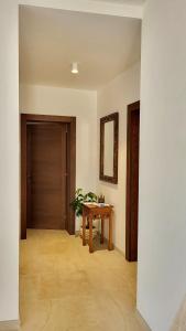 a hallway with a wooden table and a door at Un'oasi di pace in riva al mare in Pittulongu
