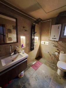 a bathroom with a sink and a toilet at Panorama apartment with a charming view of Cairo International Airport All the apt for you with free airport pick up or drop off limousine شقة بانوراما بإطلالة ساحرة على مطار القاهرة الدولي in Cairo