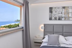 a bedroom with a bed and a large window at Luxury Apartments Luna in Tučepi