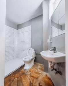 a bathroom with a toilet and a sink at The Kichwa House in Kiwengwa