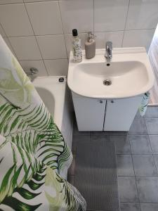 a bathroom with a white sink and a toilet at Chill Studio in Łódź