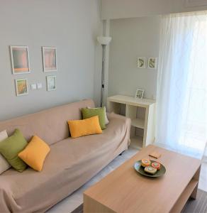 a living room with a couch and a table at Central, Bright and Comfortable Apartment with balcony in Athens