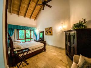 a bedroom with a bed and a ceiling fan at 5-Bedroom Villa with Private Pool, Maid and Golf Course Views at Casa de Campo Resort in La Romana
