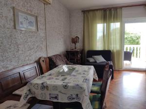 a room with a table and a chair and a room with a table at CHEAPEST APARTMENTS WITH PANORAMIC SEA VIEW CLOSE SANDY BEACH CRIKVENICA about 150m to sea in Crikvenica