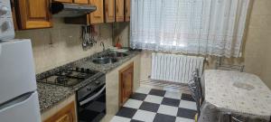 a small kitchen with a sink and a stove at Camiño Loureiro in Combarro