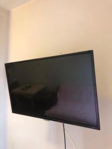 a flat screen tv hanging on a wall at Apartman Sunce in Golubac