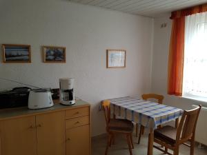 a kitchen with a table and a table and chairs at 1-Zi Fewo Rankwitz,Usedom in Rankwitz